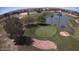 Picturesque golf course view with lush green and water features with mature trees and desert landscaping at 6751 S Callaway Dr, Chandler, AZ 85249