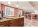Open kitchen featuring a breakfast bar with seating and views of the living area at 6751 S Callaway Dr, Chandler, AZ 85249