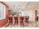 Kitchen bar area with seating and stylish pendant lighting overlooking the modern kitchen at 6751 S Callaway Dr, Chandler, AZ 85249