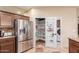 Kitchen area with stainless steel refrigerator and an open pantry for optimal storage at 6751 S Callaway Dr, Chandler, AZ 85249