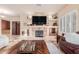 Comfortable living room with built-in shelving and a stone fireplace at 6751 S Callaway Dr, Chandler, AZ 85249
