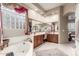 Main bathroom showcasing a soaking tub, dual vanities, and a glass block window for privacy at 6751 S Callaway Dr, Chandler, AZ 85249