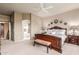 Inviting main bedroom showcasing a luxurious bed frame and an ensuite bathroom entrance at 6751 S Callaway Dr, Chandler, AZ 85249