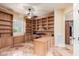 Spacious office with custom built-in shelving and drawers, perfect for a home workspace at 6751 S Callaway Dr, Chandler, AZ 85249