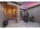 Covered patio with comfortable seating and a decorative entrance with flowers at 6751 S Callaway Dr, Chandler, AZ 85249