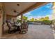 Inviting covered patio features comfortable seating, ceiling fan and views of the pool and landscaped backyard at 6751 S Callaway Dr, Chandler, AZ 85249