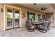 Covered patio featuring French doors, ceiling fan, tiled flooring, and outdoor seating at 6751 S Callaway Dr, Chandler, AZ 85249