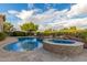 Backyard oasis with freeform pool, spa with rock waterfall, mature trees and lush landscaping at 6751 S Callaway Dr, Chandler, AZ 85249