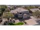 Aerial view of the property showcasing its well-maintained landscaping, three-car garage and tile roof at 6929 E Trailridge Cir, Mesa, AZ 85207