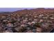 Breathtaking aerial view of the residential community nestled in the mountains at sunset at 6929 E Trailridge Cir, Mesa, AZ 85207