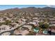Aerial shot of the neighborhood showcasing homes with pools and well-maintained landscaping with desert mountain views at 6929 E Trailridge Cir, Mesa, AZ 85207