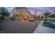 Expansive backyard with a cozy firepit, string lights, and ample patio space for entertaining guests at 6929 E Trailridge Cir, Mesa, AZ 85207