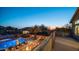 Scenic balcony view overlooking a backyard with a refreshing pool and inviting lounge area at twilight at 6929 E Trailridge Cir, Mesa, AZ 85207