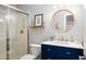 Charming bathroom featuring a glass shower and a vanity with a round mirror at 6929 E Trailridge Cir, Mesa, AZ 85207