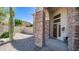 Charming front porch with stone pillars and a wooden door with a decorative wreath at 6929 E Trailridge Cir, Mesa, AZ 85207