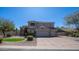 Beautiful home featuring a three-car garage, manicured lawn, and mature trees at 6929 E Trailridge Cir, Mesa, AZ 85207