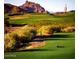 Scenic golf course view with lush green fairways and mountain backdrop at 6929 E Trailridge Cir, Mesa, AZ 85207