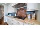 Close-up of kitchen featuring blue backsplash, stainless steel gas range, and granite countertops at 6929 E Trailridge Cir, Mesa, AZ 85207