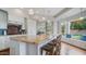 Stylish kitchen with a center island, seating, and a window seat with a view to the backyard at 6929 E Trailridge Cir, Mesa, AZ 85207