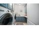 Well-lit laundry room with blue cabinetry, white countertops, and modern washer and dryer at 6929 E Trailridge Cir, Mesa, AZ 85207