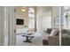 Bright living room with a cozy couch, tall arched windows, and modern decor offering a comfortable space at 6929 E Trailridge Cir, Mesa, AZ 85207