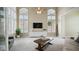Well-lit living room with tall windows, plush carpet, and stylish furnishings creating an inviting atmosphere at 6929 E Trailridge Cir, Mesa, AZ 85207