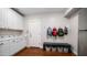 Well-organized mudroom with custom cabinets and a bench with storage baskets at 6929 E Trailridge Cir, Mesa, AZ 85207
