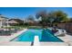 Backyard pool features a diving board, lounge chairs, a waterfall and a slide, offering an oasis for Gathering fun at 6929 E Trailridge Cir, Mesa, AZ 85207