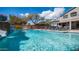 Sparkling pool features a waterfall, lounge chairs, and umbrella, perfect for relaxation and backyard entertaining at 6929 E Trailridge Cir, Mesa, AZ 85207