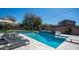 Backyard pool features a slide, tanning deck, lounge chairs, and a waterfall for ultimate outdoor enjoyment at 6929 E Trailridge Cir, Mesa, AZ 85207
