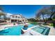 Luxury backyard with a sparkling pool, spa, lush landscaping, and outdoor lounge area, great for entertaining at 6929 E Trailridge Cir, Mesa, AZ 85207