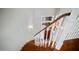 Classic curved staircase with wooden steps and white spindles leading to a bright landing at 6929 E Trailridge Cir, Mesa, AZ 85207