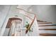 Elegant staircase with wood treads and a white banister, showcasing architectural details at 6929 E Trailridge Cir, Mesa, AZ 85207