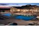 Luxurious pool area with ample seating and well-maintained landscaping at the community clubhouse at 6929 E Trailridge Cir, Mesa, AZ 85207