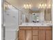 Bright bathroom featuring a glass enclosed shower, and double sink vanity with wood cabinets at 7115 E Olla Ave, Mesa, AZ 85212