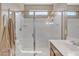 Bright bathroom featuring a glass enclosed shower, and single sink vanity with wood cabinets at 7115 E Olla Ave, Mesa, AZ 85212