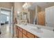 Bright bathroom featuring a double sink vanity with a large mirror and views to a bedroom at 7115 E Olla Ave, Mesa, AZ 85212