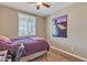 Bedroom featuring wood-look floors, a ceiling fan, a window, and neutral colored walls at 7115 E Olla Ave, Mesa, AZ 85212