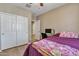 Bedroom featuring wood-look floors, a ceiling fan, a window, and neutral colored walls at 7115 E Olla Ave, Mesa, AZ 85212