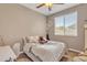 Cozy bedroom with neutral walls, wood-look flooring, a window, and a ceiling fan at 7115 E Olla Ave, Mesa, AZ 85212