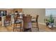 Dining area with hardwood floors, adjacent to kitchen with granite countertops and stainless appliances at 7115 E Olla Ave, Mesa, AZ 85212