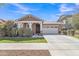 Inviting one-story home with a two-car garage, neutral paint, covered entry, and fresh landscaping at 7115 E Olla Ave, Mesa, AZ 85212