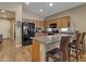 Well-equipped kitchen features black appliances, granite countertops, and an island at 7115 E Olla Ave, Mesa, AZ 85212