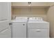 Bright laundry room with white washer and dryer at 7115 E Olla Ave, Mesa, AZ 85212