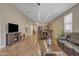 Open-concept living space featuring hardwood floors, recessed lighting, and a cozy fireplace at 7115 E Olla Ave, Mesa, AZ 85212