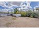 Vast backyard offering numerous possibilities for outdoor enjoyment, with mature trees and ample space at 7131 E Cholla St, Scottsdale, AZ 85254