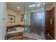Bathroom with a marble shower, tub, window, and tile accents at 7131 E Cholla St, Scottsdale, AZ 85254