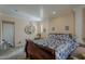 A bedroom with a queen-size bed, neutral walls, white trim, and a decorative support column at 7131 E Cholla St, Scottsdale, AZ 85254