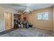A bedroom with a window, closet, carpet, and peach colored walls at 7131 E Cholla St, Scottsdale, AZ 85254