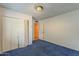 Bedroom with a closet, light fixture, and blue carpet at 7131 E Cholla St, Scottsdale, AZ 85254